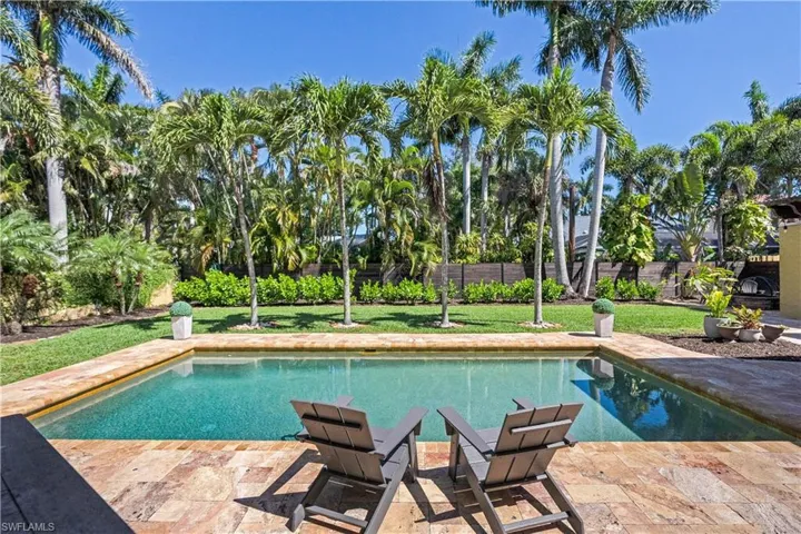 View of swimming pool featuring a patio and a lawn
