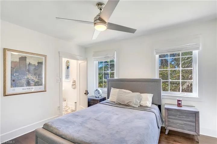 Bedroom with ceiling fan and dark hardwood / wood-style floors
