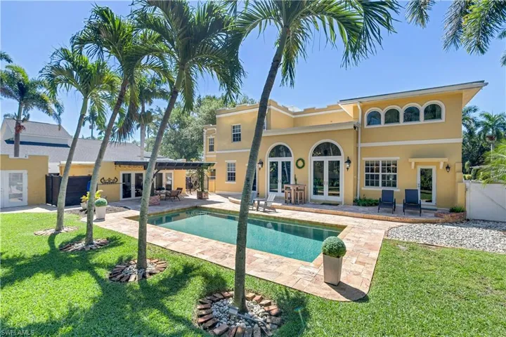 View of pool with a patio, french doors, and a lawn