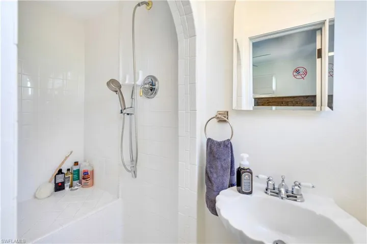 Bathroom with tiled shower and sink