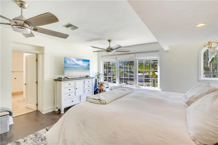 Bedroom with ceiling fan and dark hardwood / wood-style flooring