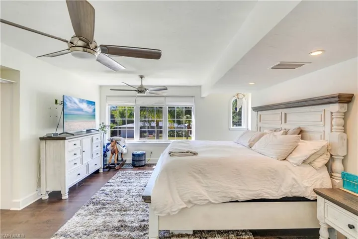 Bedroom featuring ceiling fan and dark hardwood / wood-style flooring