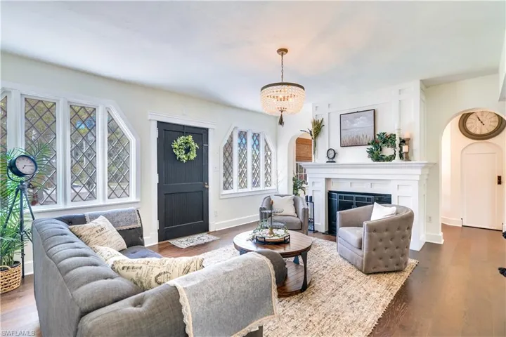 Living room featuring wood-type flooring and an inviting chandelier