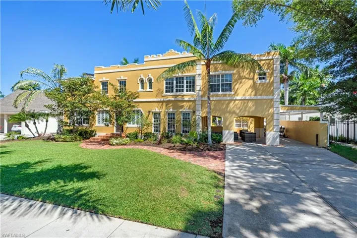 Mediterranean / spanish house featuring a front lawn, a carport, and central AC unit