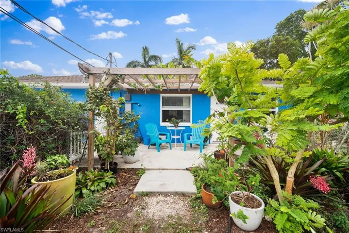 Rear view of property featuring a pergola and a patio