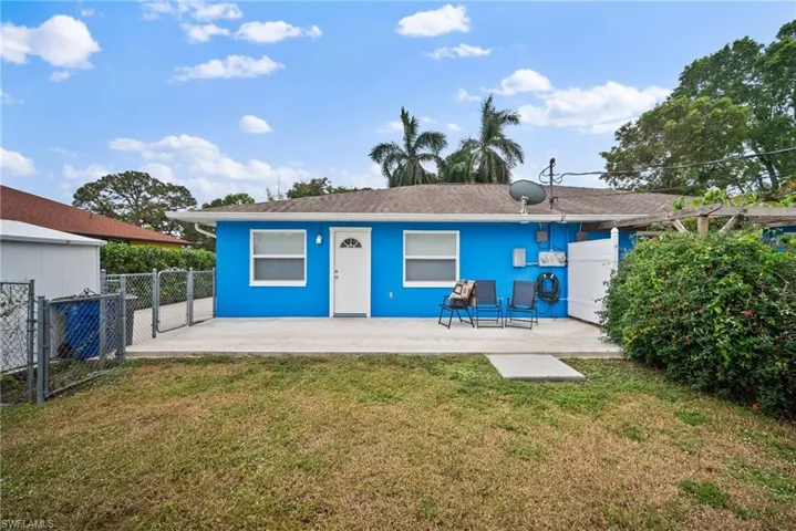 Back of property with a patio area and a lawn