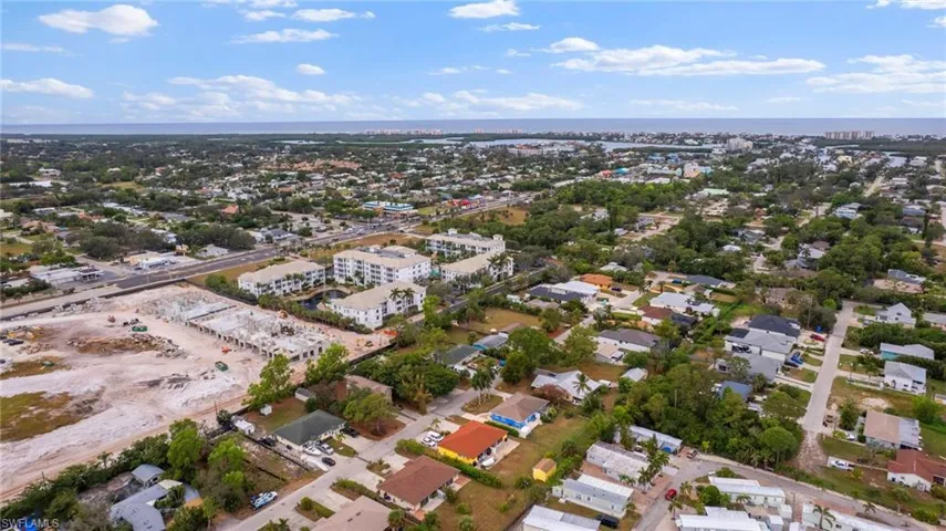 Birds eye view of property with a water view