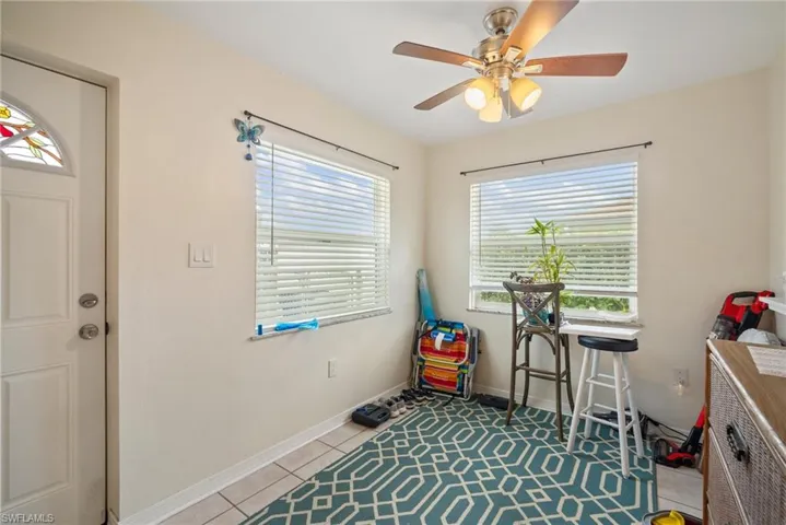 Miscellaneous room with ceiling fan and light tile patterned flooring