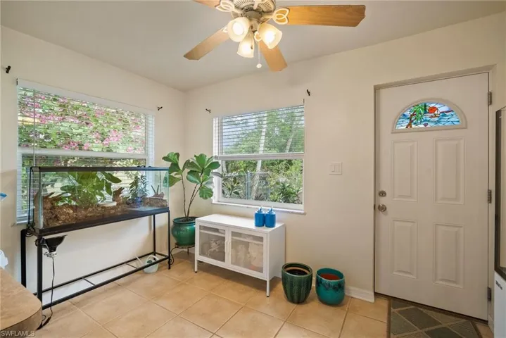 Tiled foyer entrance with ceiling fan