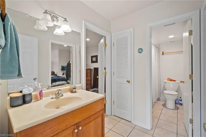 Bathroom with tile patterned flooring, vanity, and toilet