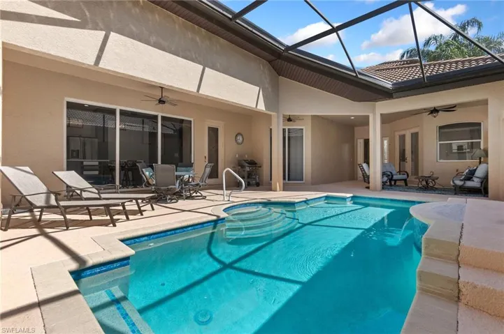 Back of house featuring ceiling fan, a patio, a tiled roof, and stucco siding