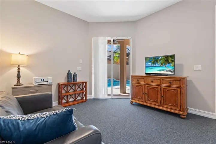 Living room with carpet flooring and baseboards