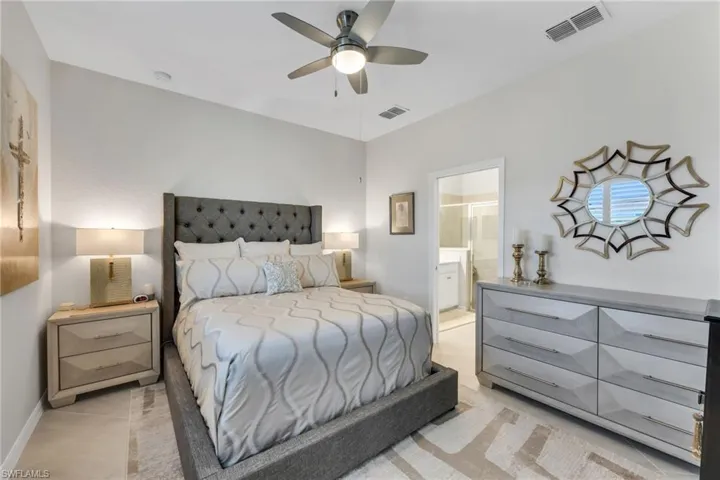 Bedroom with a ceiling fan and ensuite bathroom