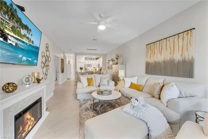 Living room with ceiling fan and tile flooring