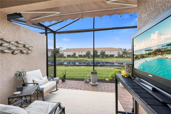 Extended Rear Lanai featuring outdoor dining space, a water/lake view, and brick paver patio