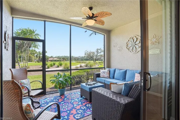 Sunroom featuring an outdoor living space and a ceiling fan