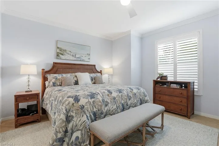 Bedroom featuring crown molding, a ceiling fan, and light tile patterned floors