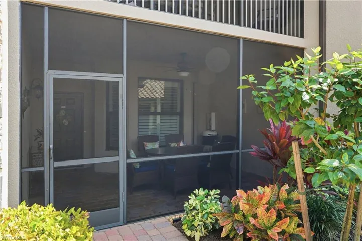 Doorway to property with a sunroom