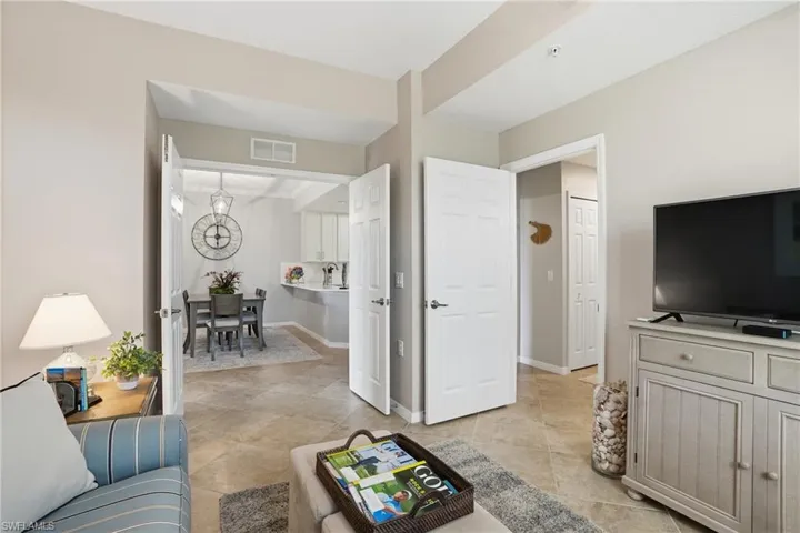 Living area with baseboards and a chandelier