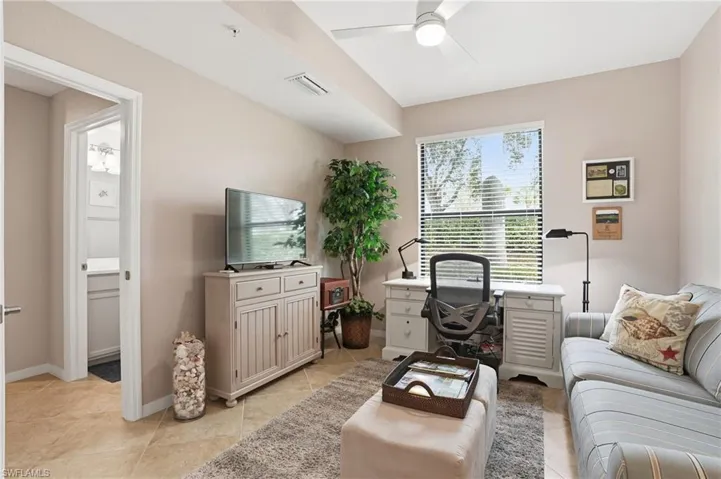 Office area featuring ceiling fan and light tile patterned floors