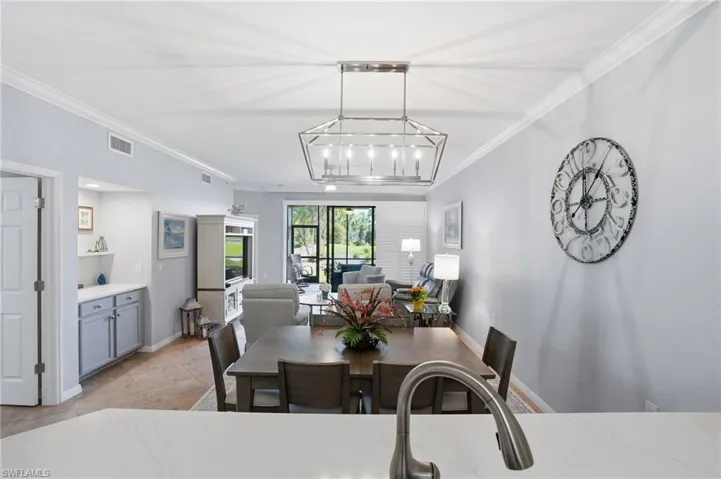 Dining space featuring ornamental molding and hanging lights