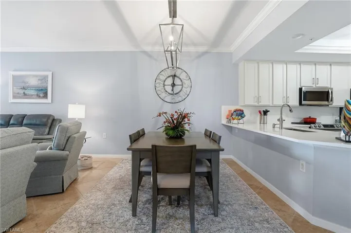 Dining room with ornamental molding and baseboards