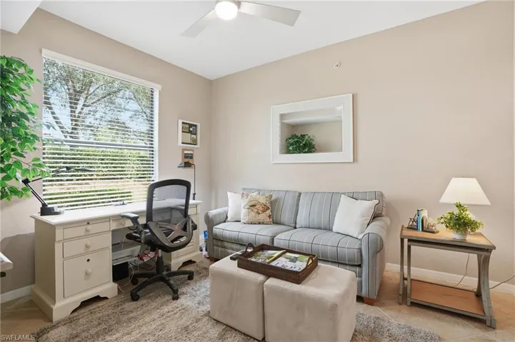 Office area featuring light tile patterned floors and a ceiling fan