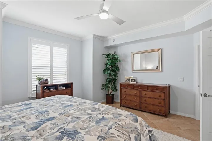 Bedroom featuring crown molding and a ceiling fan