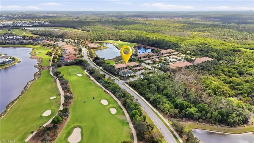 Aerial perspective of suburban area with a large body of water and a golf club