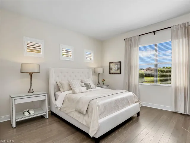 Bedroom with baseboards and wood finished floors