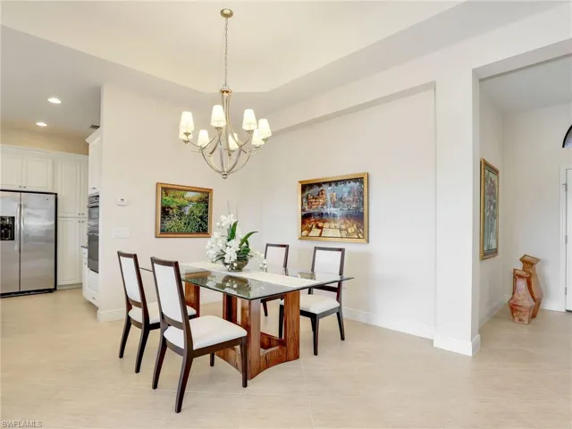 Dining space with baseboards, a chandelier, and recessed lighting