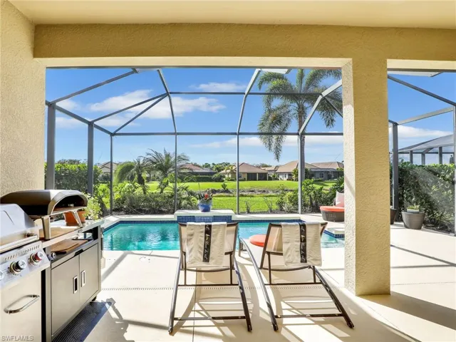 Pool with a patio, exterior kitchen, and a lanai