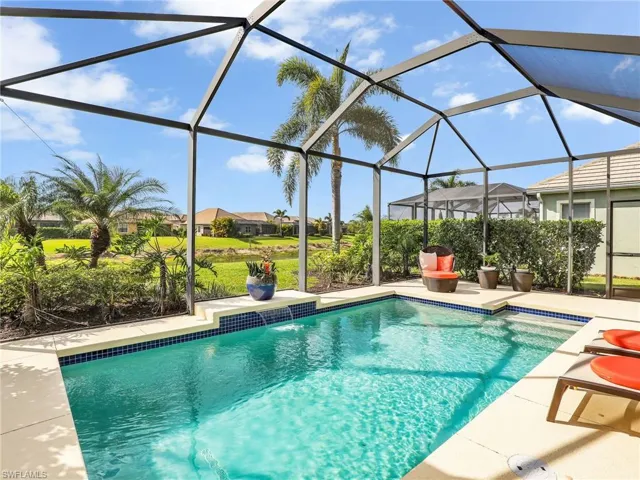 Outdoor pool featuring glass enclosure and a patio area