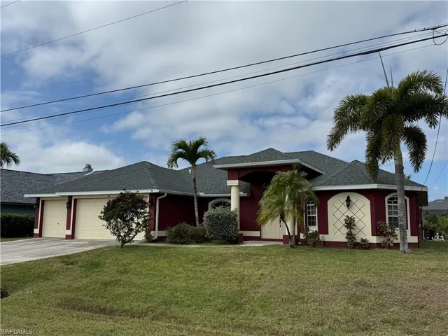 Ranch-style house featuring roof with shingles, a front yard, a garage, driveway, and stucco siding