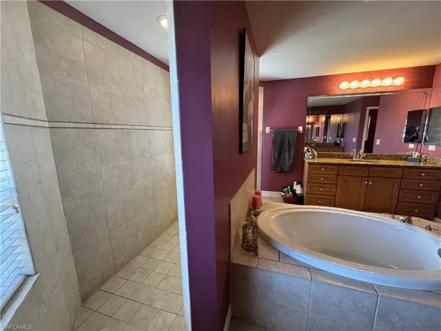 Bathroom featuring vanity and a garden tub