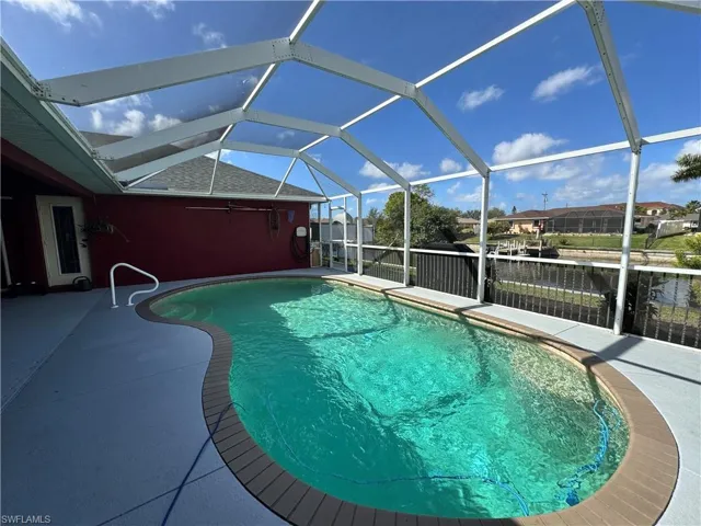 Outdoor pool with a sunroom, a lanai, and a patio area