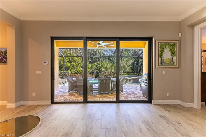 Doorway featuring crown molding and light hardwood / wood-style floors