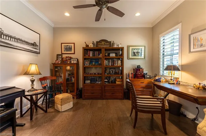 Office featuring ornamental molding, dark wood-type flooring, and ceiling fan