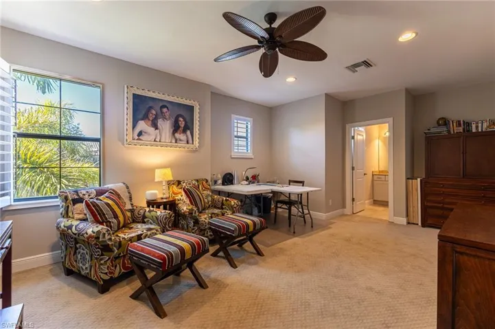 Sitting room with light carpet and ceiling fan