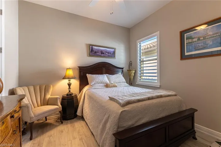 Bedroom with ceiling fan and light hardwood / wood-style flooring