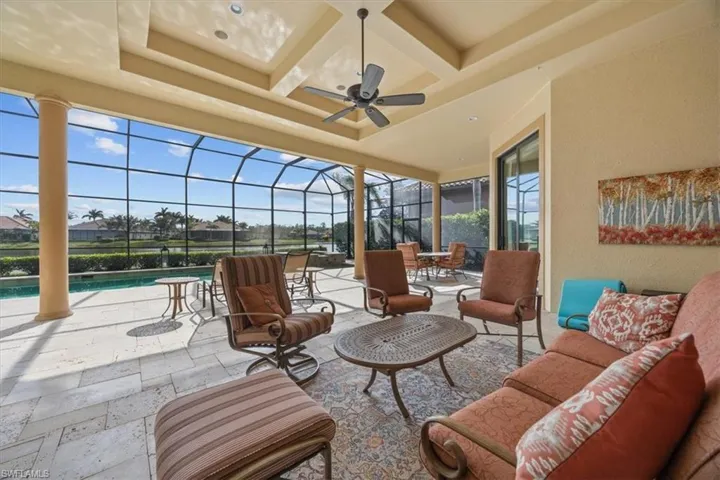 View of patio featuring a lanai, an outdoor pool, an outdoor hangout area, and a ceiling fan