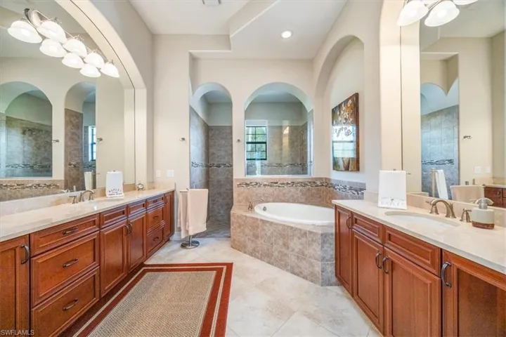 Full bathroom with a garden tub, tile patterned floors, a sink, and a walk in shower