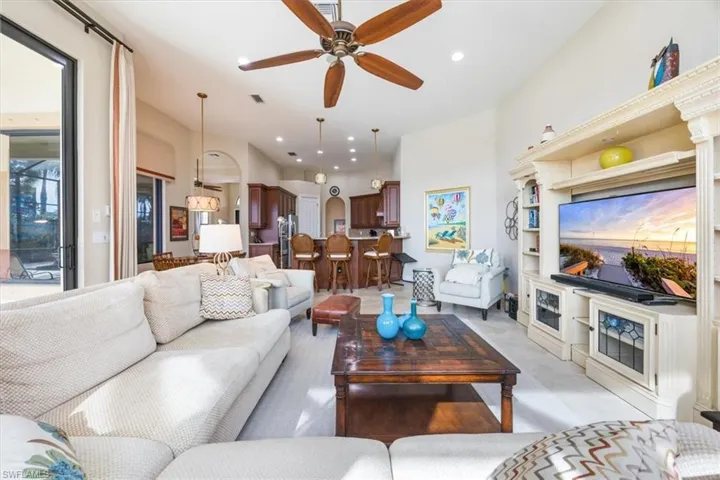 Living area with a ceiling fan, visible vents, and recessed lighting