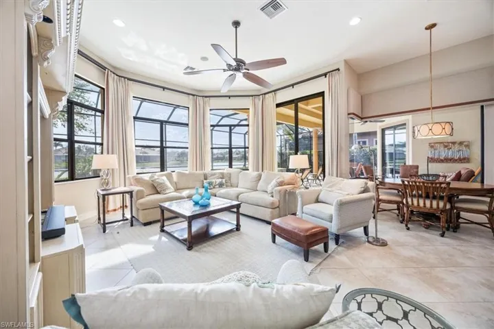Living room with a ceiling fan, visible vents, recessed lighting, and light tile patterned flooring
