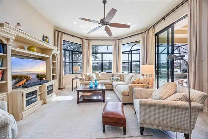 Living room featuring baseboards, recessed lighting, ceiling fan, and light tile patterned flooring