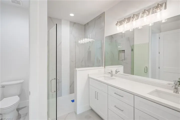 Dual vanity with undermount sinks and white countertops