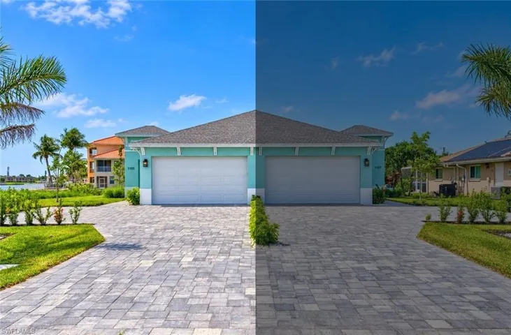 Paver driveway with manicured landscaping, two-car garage, and light blue exterior siding