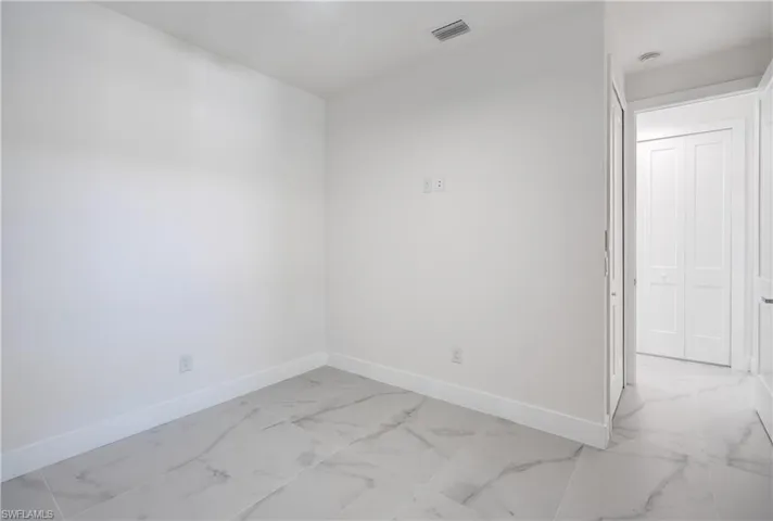 White walls and white trim create a bright interior with tile flooring