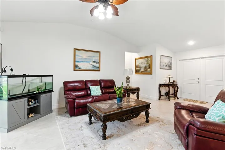 Living area with vaulted ceiling and ceiling fan