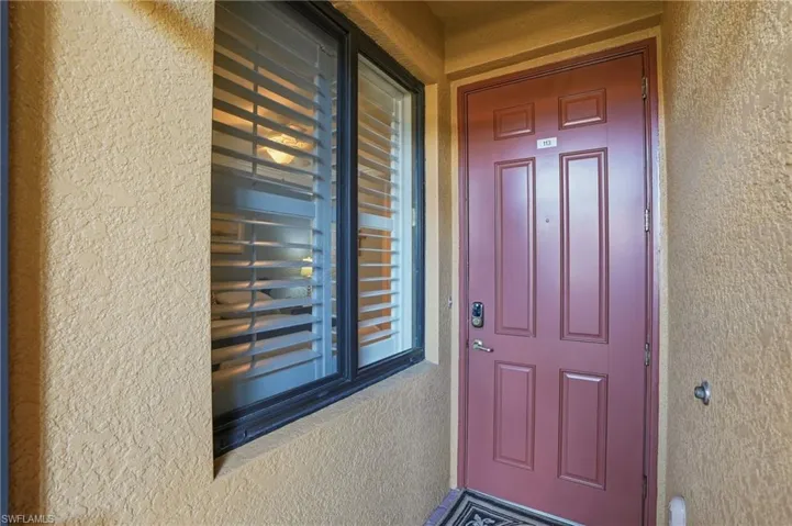 Property entrance featuring stucco siding